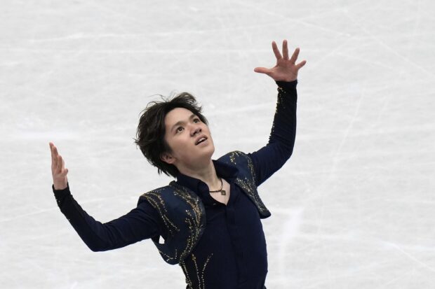Shoma Uno is captured in a graceful figure skating pose on the ice rink, 2K Desktop Wallpaper
