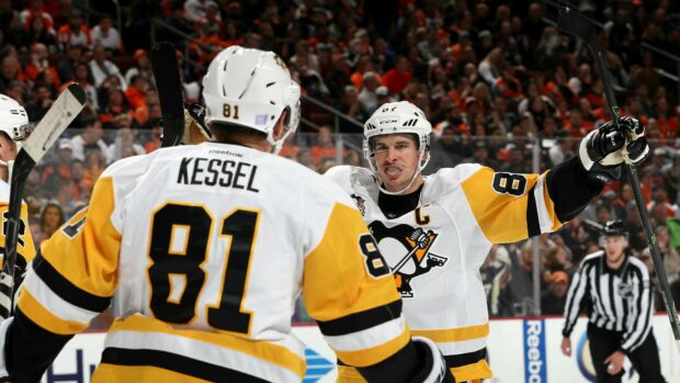 Sidney Crosby celebrates with teammate during a hockey game, HD Desktop Wallpaper