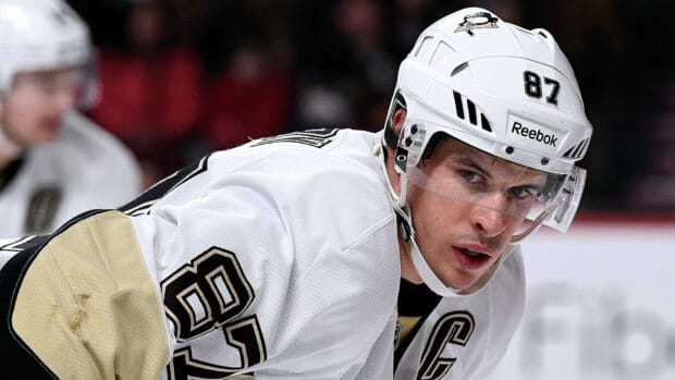 Sidney Crosby is intensely focused on the ice rink during a game, HD Desktop Wallpaper