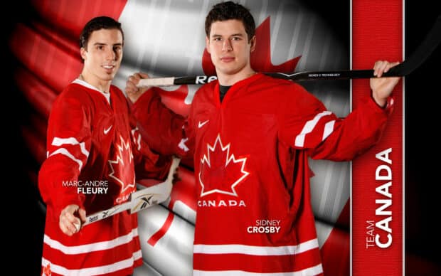 Sidney Crosby stands in front of a Canadian flag wearing his Team Canada hockey jersey, HD Desktop Wallpaper