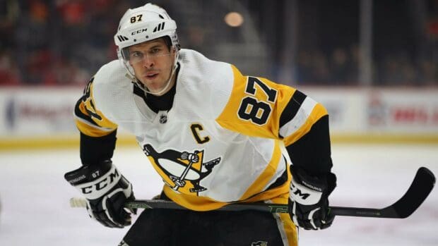 Sidney Crosby is focused during a hockey game wearing a Penguins jersey, HD Desktop Wallpaper