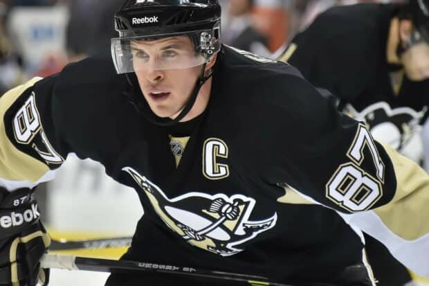 Sidney Crosby focused during an ice hockey game in black uniform, HD Desktop Wallpaper