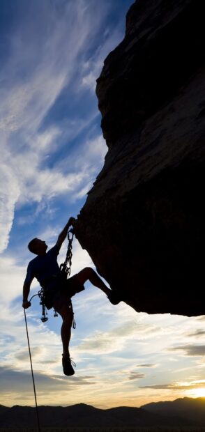 A rock climber climbs a steep cliff during sunset in this rock climbing wallpapers, HD Phone Wallpaper