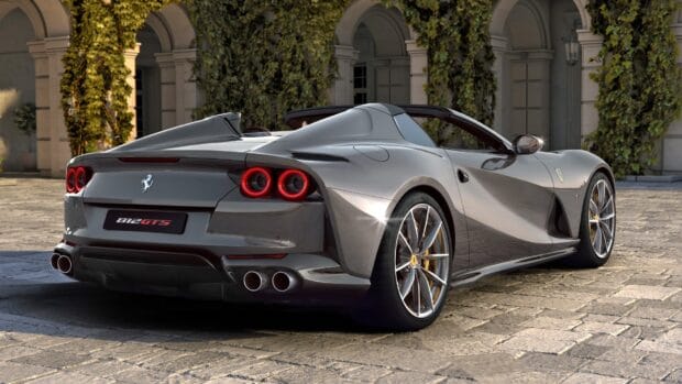 A silver Ferrari 812 GTS is parked on a stone driveway under sunlight, HD Desktop Wallpaper