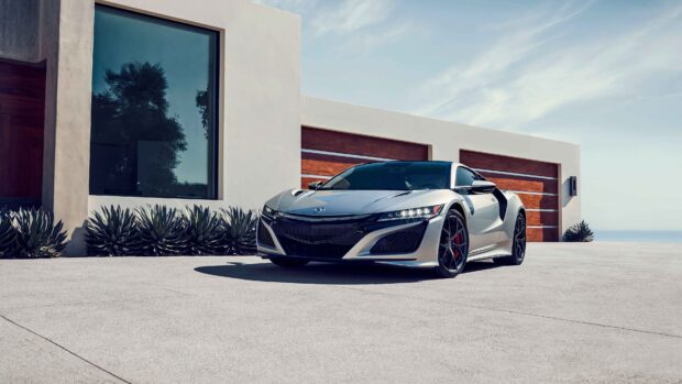 A silver Honda NSX is parked on a driveway beside a modern home under a blue sky, 4K Desktop Wallpaper