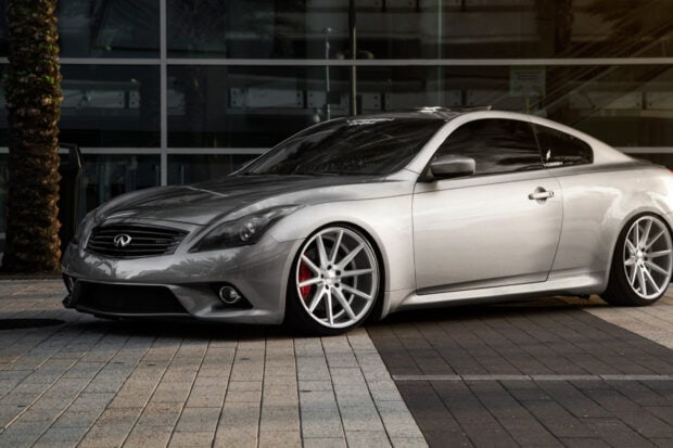 A sleek Infiniti G37 is parked on the pavement with custom wheels, HD Desktop Wallpaper