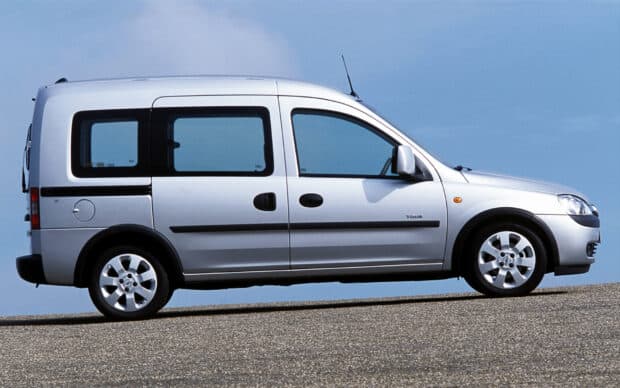 A silver Opel Combo vehicle is shown parked on a paved road under a clear blue sky, HD Desktop Wallpaper