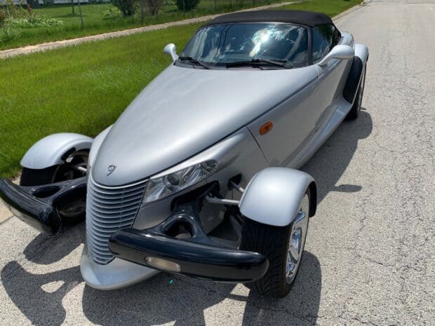 A silver Plymouth Prowler is parked on a sunny road next to a grassy area, HD Desktop Wallpaper