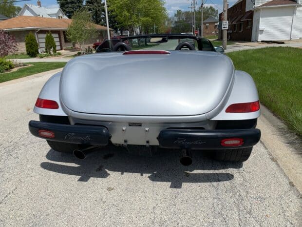 The silver Plymouth Prowler is parked on a sunny suburban street with houses in the background, HD Desktop Wallpaper