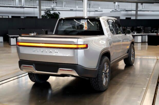 Rivian Automotive Wallpapers displayed in modern showroom, HD Desktop Wallpaper