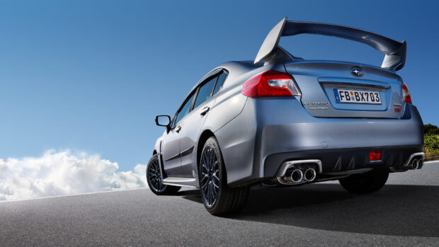 Silver Subaru WRX is parked on a clear road under blue sky, 4K Desktop Wallpaper