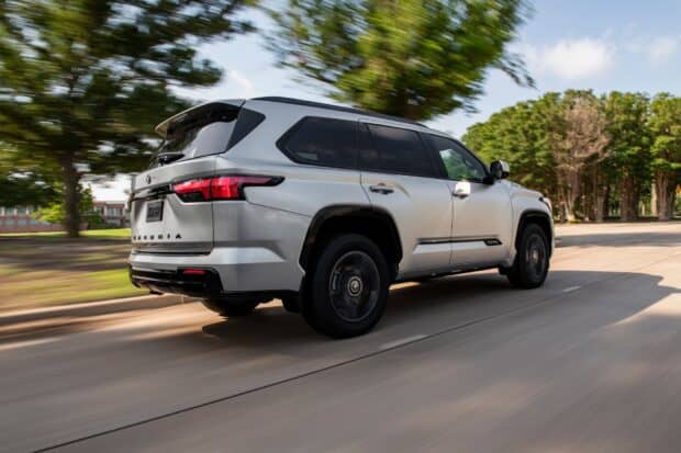 A silver Toyota Sequoia is driving through a tree lined street under a partly cloudy sky, HD Desktop Wallpaper