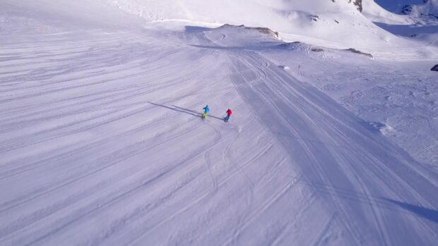 Two skiers enjoy skiing on snowy mountain slopes, 4K Desktop Wallpaper