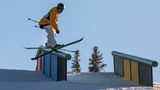 A person in yellow jacket is skiing on a rail in the snow park, HD Desktop Wallpaper
