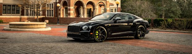A sleek black Bentley Continental GT parked in a historic courtyard, 4K Desktop Wallpaper