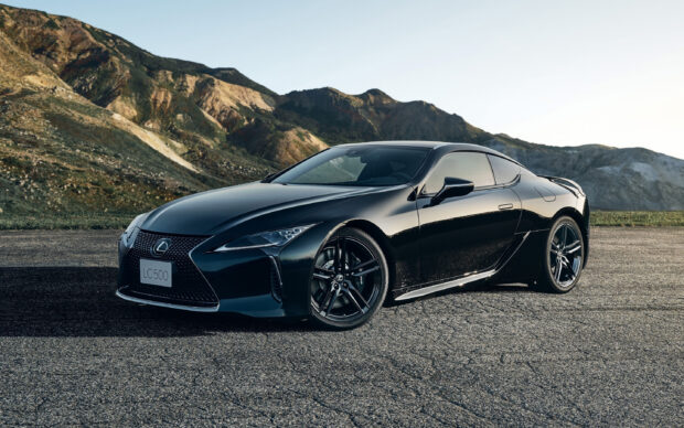 A black Lexus LC500 parked on an asphalt surface with mountains in the background, 2K Desktop Wallpaper