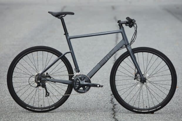 A sleek Bmc Bikes design is shown on a road surface with detailed gears and frame, 2K Desktop Wallpaper