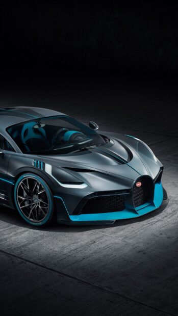 A sleek Bugatti Divo with blue accents is parked in a dark setting, 4K Phone Wallpaper