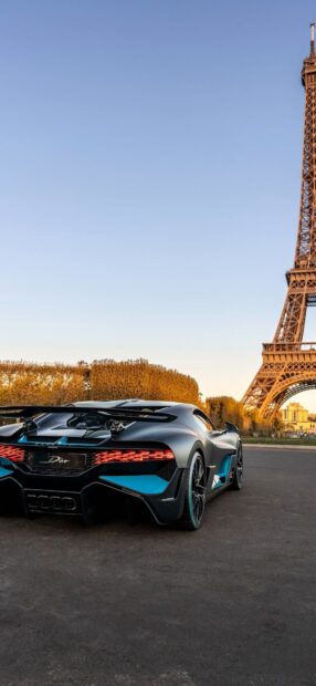 A sleek Bugatti Divo is parked near the Eiffel Tower during sunset in Paris, HD Phone Wallpaper