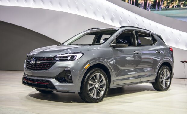 A sleek gray Buick Encore is displayed in a modern showroom setting, 2K Desktop Wallpaper
