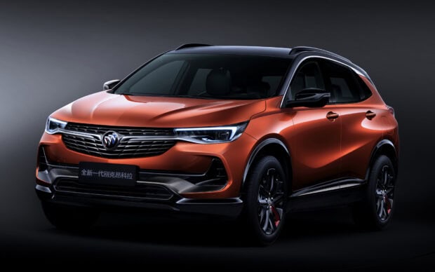 A sleek orange Buick Encore is shown from the front side, showcasing its modern headlights and grille, HD Desktop Wallpaper