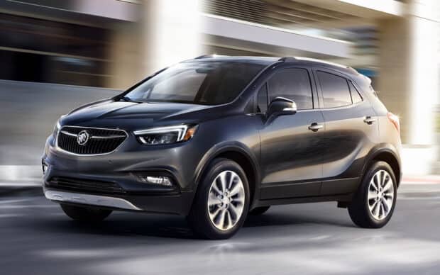 A sleek Buick Encore drives smoothly on the road showcasing its modern design, HD Desktop Wallpaper