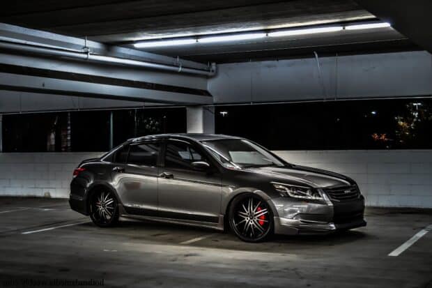 A sleek Honda Accord with custom black wheels is parked in a dimly lit garage space at night, HD Desktop Wallpaper