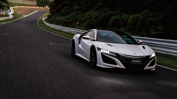 A white Honda NSX driving fast on a curvy track surrounded by green trees, 4K Desktop Wallpaper