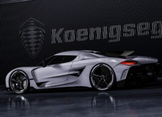 A sleek Koenigsegg sports car is parked indoors with the brand's logo in the background, 4K Desktop Wallpaper