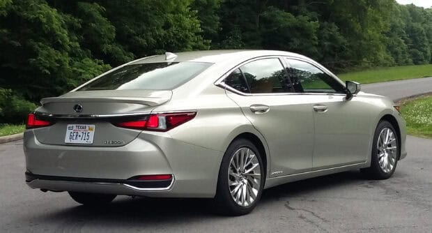 A silver Lexus Es car parked on a road near green trees, 2K Desktop Wallpaper
