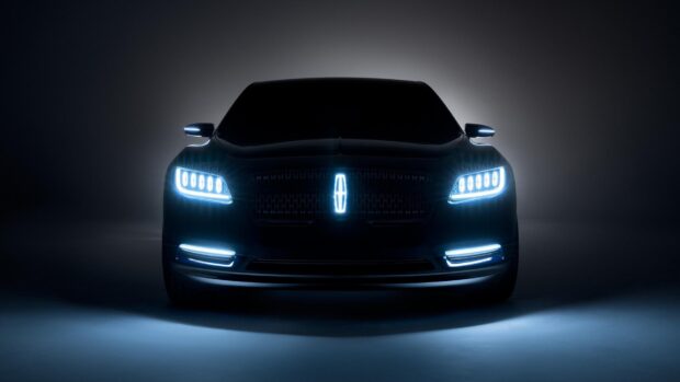 A sleek Lincoln car front view with bright LED headlights and illuminated logo, HD Desktop Wallpaper