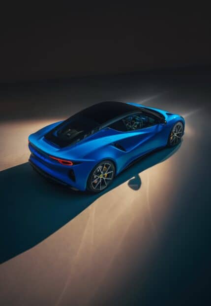 A blue Lotus Emira is shown from above with illuminated details in a dark environment, 2K Mobile Wallpaper