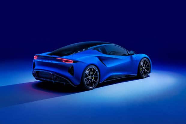 A blue Lotus Emira is showcased from the rear with glowing taillights and detailed wheels, 2K Desktop Wallpaper