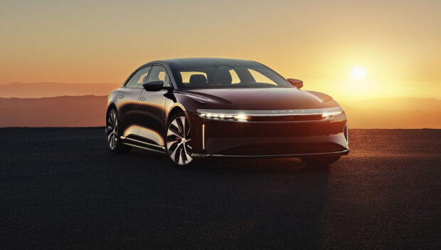 A Lucid Motors car is parked on a road with the sun setting behind hills, HD Desktop Wallpaper