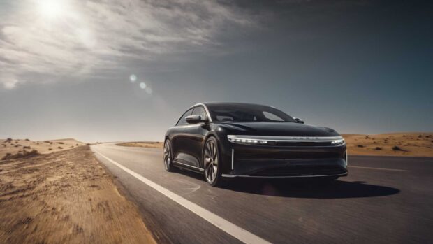 A black Lucid Motors car is driving on an open desert highway under a cloudy sky, HD Desktop Wallpaper
