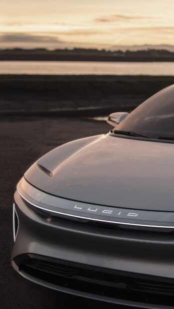 The sleek front view of a Lucid Motors car during sunset showcases its modern design, 2K Phone Wallpaper