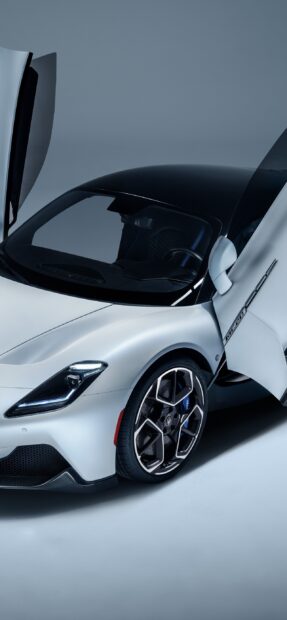 The sleek Maserati MC20 with its scissor doors open displays elegant design, 2K Phone Wallpaper