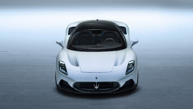 A white Maserati MC20 sports car is shown from the front with a clear view of the grille and headlights, 4K Desktop Wallpaper