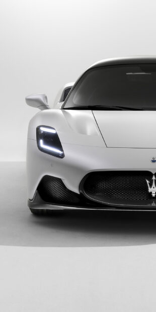 The sleek Maserati Mc20 features a sharp front grille and illuminated headlights in white, 2K Phone Wallpaper