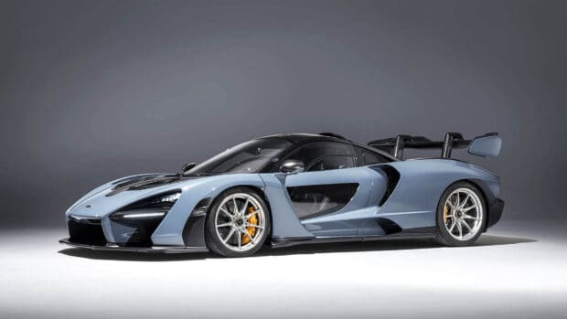 A sleek McLaren Senna sports car is showcased in a studio with a gray background, HD Desktop Wallpaper