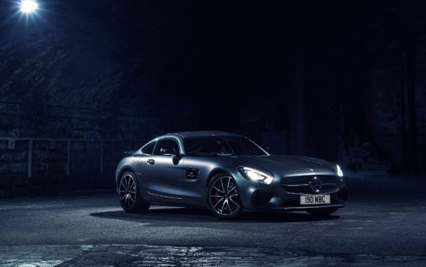 A Mercedes Benz Amg Gt is parked under a bright light in a dark urban area, 2K Desktop Wallpaper