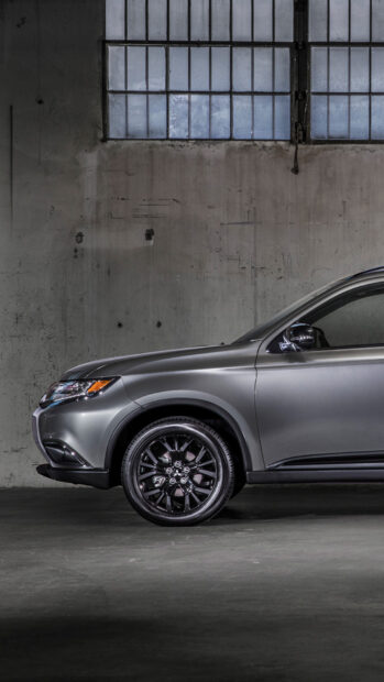 A sleek Mitsubishi Outlander is parked inside an industrial building with large windows, HD Mobile Wallpaper