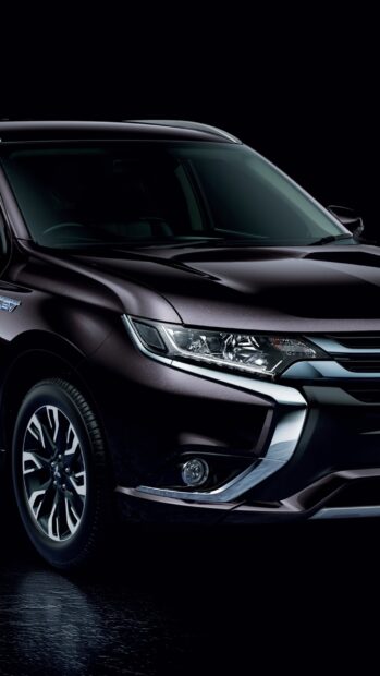 The sleek front design of the Mitsubishi Outlander is shown in a close up view, 2K Phone Wallpaper