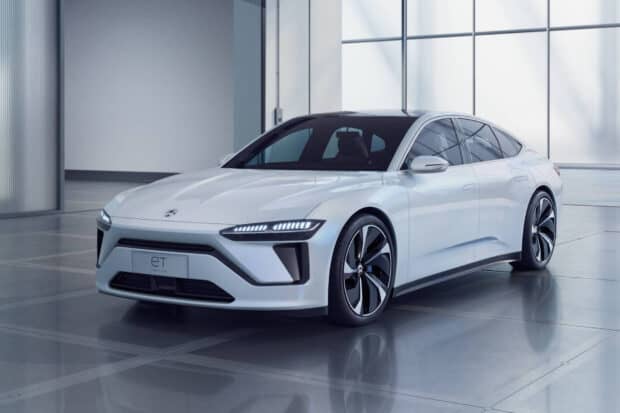 A white Nio Auto car is parked indoors with bright natural light flooding the room, HD Desktop Wallpaper