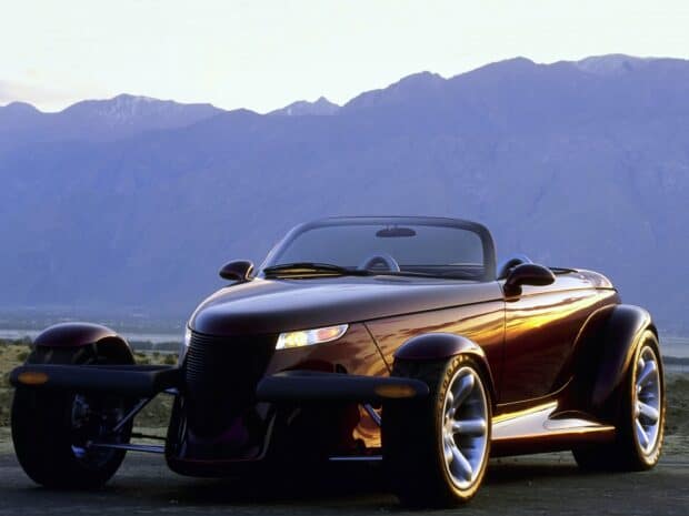 A sleek Plymouth Prowler convertible is parked with mountains in the background, HD Desktop Wallpaper