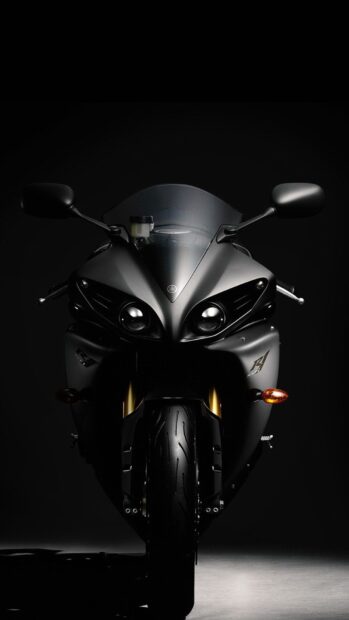 A sleek street bike shines with sharp headlights in dark surroundings, HD Phone Wallpaper