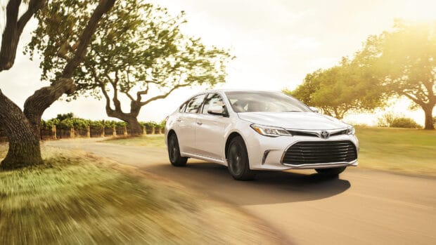 A white Toyota Avalon is driving along a tree lined road during sunset, HD Desktop Wallpaper