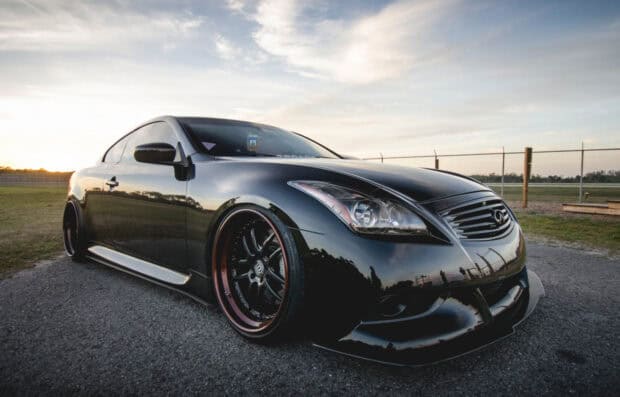A sleek black Infiniti G37 car is parked outdoors with a scenic sky background, HD Desktop Wallpaper