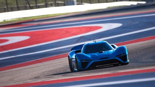 A sleek blue Nio Auto is speeding on a colorful racing track, 4K Desktop Wallpaper