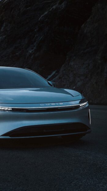 A sleek Lucid Motors car front view is captured on a dark road, 4K Phone Wallpaper